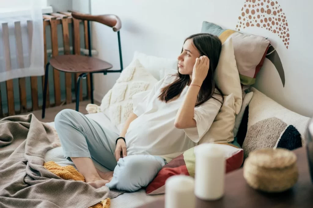 Pregnant Mother Thinking on Sofa